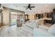 Spacious living room with wood floors, recessed lighting, neutral walls, and access to both the kitchen and patio at 243 Sun Glaze Ave, Henderson, NV 89011