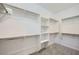 Bright, open walk-in closet with shelving, rods, and carpeted floor at 243 Sun Glaze Ave, Henderson, NV 89011