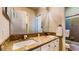 Bathroom featuring double sinks with granite countertops and a large mirror at 25 Luce Del Sole # 3, Henderson, NV 89011