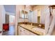 Dual sinks and granite countertops in the bathroom, with luxury vinyl plank flooring at 25 Luce Del Sole # 3, Henderson, NV 89011