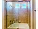 Bathroom featuring a glass-enclosed shower and a tiled surround at 25 Luce Del Sole # 3, Henderson, NV 89011