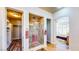 Open bathroom concept featuring dual closets, glass shower, and an arched entrance to the bedroom at 25 Luce Del Sole # 3, Henderson, NV 89011