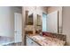 Bathroom featuring granite countertops, a single sink, and a walk-in closet at 25 Luce Del Sole # 3, Henderson, NV 89011