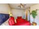Bright bedroom with plant, ceiling fan, walk-in closet, and wood-look flooring at 25 Luce Del Sole # 3, Henderson, NV 89011