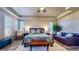 Spacious primary bedroom with accent furniture, hardwood floors, plantation shutters, and tray ceilings at 25 Luce Del Sole # 3, Henderson, NV 89011