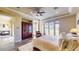 Primary bedroom with a fireplace, armoire, and french doors to the backyard at 25 Luce Del Sole # 3, Henderson, NV 89011