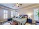Bedroom featuring hardwood floors, tray ceiling, and white plantation shutters at 25 Luce Del Sole # 3, Henderson, NV 89011