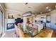 Dining area open to kitchen with a modern light fixture and view to fireplace at 25 Luce Del Sole # 3, Henderson, NV 89011
