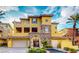 Elegant home showcases a stone facade, private balcony, and a two-car garage with ample parking at 25 Luce Del Sole # 3, Henderson, NV 89011