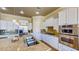 Open kitchen featuring a large center island with granite countertops and stainless steel appliances at 25 Luce Del Sole # 3, Henderson, NV 89011