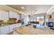 Open kitchen with granite countertops, stainless steel appliances, and eat-in dining area at 25 Luce Del Sole # 3, Henderson, NV 89011