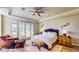 Elegant main bedroom with a cozy sitting area, French doors, and a king-sized bed at 25 Luce Del Sole # 3, Henderson, NV 89011