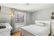Cozy bedroom featuring a bed with a patterned blanket and a window seat at 2699 Aldonza Dr, Henderson, NV 89014