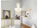 Elegant dining area with a chandelier, buffet, and view into the kitchen at 2699 Aldonza Dr, Henderson, NV 89014