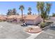 Inviting single-story home featuring desert landscaping, a tile roof, and a two-car garage at 2699 Aldonza Dr, Henderson, NV 89014