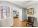 Hallway leading to an office with wood floors and a decorative painting on the wall at 2699 Aldonza Dr, Henderson, NV 89014
