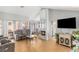 Comfortable living room with a fireplace, high ceilings, and a wall of windows at 2699 Aldonza Dr, Henderson, NV 89014