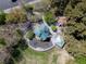 An aerial view shows the community playground, covered picnic area, and walking paths surrounded by mature trees at 2699 Aldonza Dr, Henderson, NV 89014
