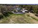 An aerial shows the community playground, covered picnic area, lush green spaces, and mature trees at 2699 Aldonza Dr, Henderson, NV 89014