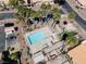 An aerial view of community pool and surrounding landscaping including palm trees and desert plants at 2699 Aldonza Dr, Henderson, NV 89014