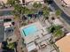 An aerial view of community pool and surrounding landscaping including palm trees and desert plants at 2699 Aldonza Dr, Henderson, NV 89014
