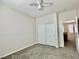 Neutral bedroom featuring a ceiling fan, carpeted floors, and an adjoining room at 2773 Drumlanrig St, Henderson, NV 89044