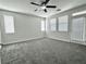 Spacious bedroom offers plush carpet, multiple windows with blinds, a ceiling fan, and a glass door at 2773 Drumlanrig St, Henderson, NV 89044