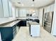 Well-lit kitchen with an island, stainless steel appliances, and dark countertops at 2773 Drumlanrig St, Henderson, NV 89044