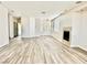 Bright living room with light wood floors and white walls and a fireplace at 2773 Drumlanrig St, Henderson, NV 89044