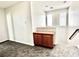 Neutral loft space with carpet and a wooden cabinet at the top of the stairs at 2773 Drumlanrig St, Henderson, NV 89044