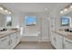 Bright bathroom with double sinks, soaking tub, and glass-enclosed shower at 3221 Birdwatcher Ave, North Las Vegas, NV 89084