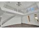 Bright, grand entryway with wrought iron staircase and chandelier, offering a warm welcome at 3221 Birdwatcher Ave, North Las Vegas, NV 89084