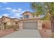 Charming two-story home with a well-manicured lawn and a two-car garage at 3221 Birdwatcher Ave, North Las Vegas, NV 89084