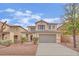 Charming two-story home with a well-manicured lawn and a two-car garage at 3221 Birdwatcher Ave, North Las Vegas, NV 89084