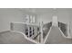 Upstairs hallway with decorative wrought iron railing and neutral carpet at 3221 Birdwatcher Ave, North Las Vegas, NV 89084