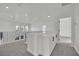 Bright open loft space with plush carpet and modern iron railing, creating an inviting area for relaxation at 3221 Birdwatcher Ave, North Las Vegas, NV 89084