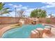 Backyard pool featuring rock waterfall, palm trees, and low-maintenance landscaping at 3221 Birdwatcher Ave, North Las Vegas, NV 89084