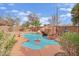 Backyard pool featuring rock waterfall, mature trees, and low-maintenance landscaping at 3221 Birdwatcher Ave, North Las Vegas, NV 89084