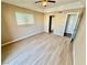 This bedroom features light hardwood floors, a ceiling fan, and a window for natural light at 3550 Bay Sands Dr # 2097, Laughlin, NV 89029
