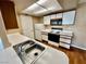 Galley kitchen featuring white appliances and laminate countertops with wood plank flooring at 3550 Bay Sands Dr # 2097, Laughlin, NV 89029