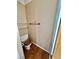 This powder room includes a toilet, towel bar, shelves and wood flooring at 3550 Bay Sands Dr # 2097, Laughlin, NV 89029