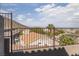 A tranquil backyard view with a decorative fence overlooking a residential area and distant mountain range at 378 Rosefinch St, Henderson, NV 89012
