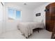 Simple bedroom features neutral tones, a window with mountain views, and modern decor at 378 Rosefinch St, Henderson, NV 89012