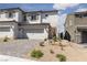 Charming two-story home showcasing a two-car garage and low-maintenance desert landscaping at 378 Rosefinch St, Henderson, NV 89012