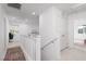 A bright hallway with white walls and carpet, features a staircase and several doorways at 378 Rosefinch St, Henderson, NV 89012