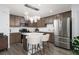 Bright kitchen features stainless steel appliances and a center island with seating at 378 Rosefinch St, Henderson, NV 89012