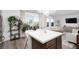 Spacious living room features a white couch with a kitchen island in the foreground at 378 Rosefinch St, Henderson, NV 89012