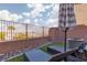 This patio features two lounge chairs under an umbrella on artificial grass at 378 Rosefinch St, Henderson, NV 89012