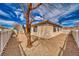 Private backyard featuring low-maintenance desert landscaping, enclosed by a white picket fence for added privacy at 3891 Sedgwick, Pahrump, NV 89061