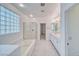 Bright bathroom with a soaking tub, glass block window, and a separate glass enclosed shower at 3891 Sedgwick, Pahrump, NV 89061